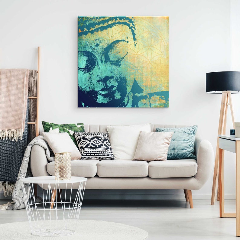 May include: An abstract painting of a Buddha face in teal and gold colours. The background is a textured gold with a geometric pattern.
