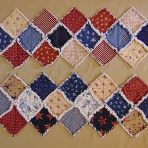 May include: A red, white, and blue patchwork quilt runner with a diamond pattern. The quilt is made of various fabrics with different patterns, including stars, stripes, and anchors.