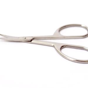 May include: A pair of silver curved cuticle scissors with a sharp point.