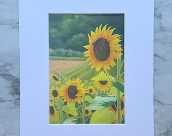 May include: A rectangular art print featuring a field of yellow sunflowers with dark brown centers under a green sky. The painting is set within a thick, plain white mat board border, creating a clean frame for the floral landscape scene.