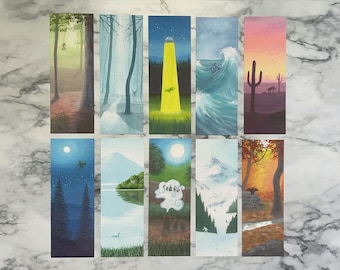 May include: Set of ten rectangular bookmarks featuring landscape paintings. Each bookmark depicts a different scene, including forests, a desert sunset, and a wave with a cyclist. The color palette varies from earthy tones to vibrant blues and oranges.