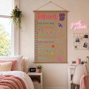 May include: A vertical hanging wall banner made of tan fabric featuring the text Senior 2027 at the top. Below the title is a checklist with various activities listed in colorful fonts, interspersed with small icons like a soccer ball and basketball.