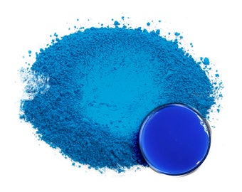 May include: A pile of bright blue powder with a small round container of blue liquid in the center.