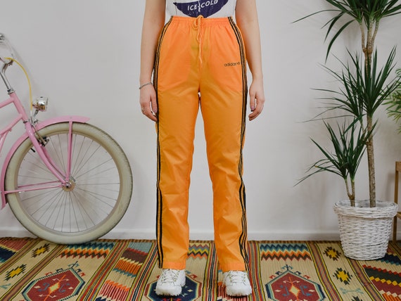 black adidas pants with orange stripes