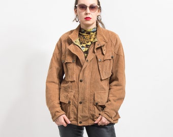 May include: A brown suede jacket with a button-up front, two large flap pockets, and two smaller pockets on the chest. The jacket has a collar and a zip-up closure.