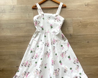 Vintage 1970s white cotton sleeveless day dress with pockets ruffled hem and dancing ladies print size XS 6-8