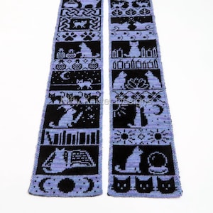 May include: A knitted scarf with a repeating pattern of black cat silhouettes and other designs on a light purple background. The scarf features various cat poses, moons, and other decorative elements.