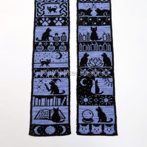May include: Two black and blue knitted panels with cat-themed patterns. The panels feature various cat silhouettes, moons, stars, and other mystical symbols. The text "Nifty Knitter Designs" is visible on the panels.