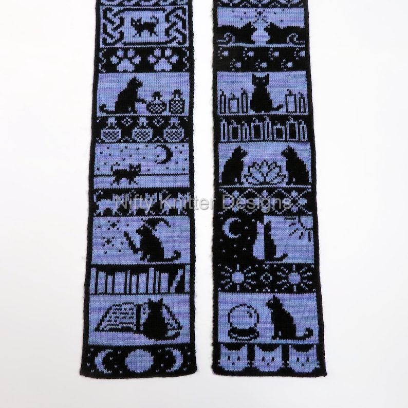 May include: Two black and blue knitted panels with cat-themed patterns. The panels feature various cat silhouettes, moons, stars, and other mystical symbols. The text "Nifty Knitter Designs" is visible on the panels.