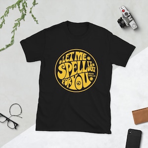 May include: Black t-shirt with a yellow circle graphic that says "Let Me Spell It Out For You" with a peace sign and the text "this is luke.ca".