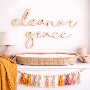 Name sign for nursery decor in boho nursery.  Wood name sign for nursery in baby girl room with wood accents and other natural nursery decor.