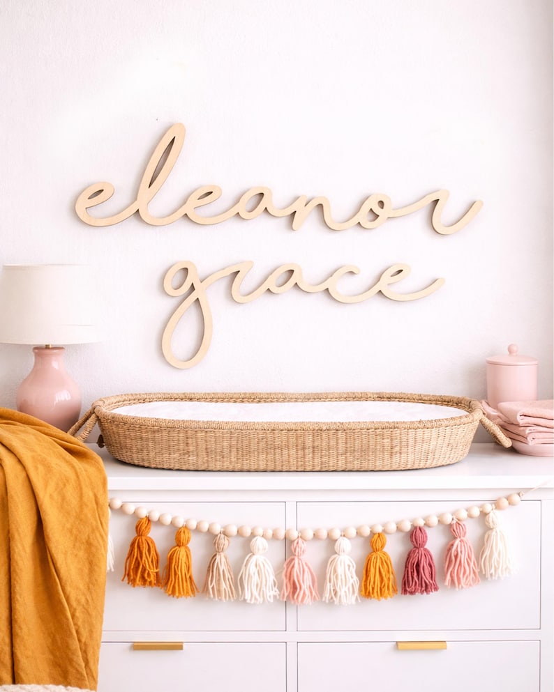 Name sign for nursery decor in boho nursery.  Wood name sign for nursery in baby girl room with wood accents and other natural nursery decor.