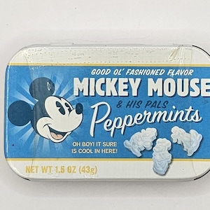 May include: A rectangular tin of Mickey Mouse & His Pals Peppermints. The tin has a blue background with Mickey Mouse's face on the left. The text reads "Good Ol' Fashioned Flavor" and "Oh Boy! It sure is cool in here!" The net weight is 1.5 oz (43g).