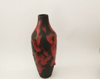May include: A red and black ceramic vase with a drip glaze design. The vase is a classic mid-century modern style.