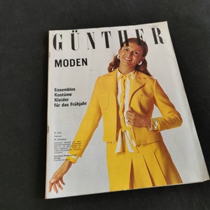 May include: A vintage fashion magazine cover with the text "GÜNTHER MODEN" and the words "Ensembles, Kostüme, Kleider für das Frühjahr." The cover features a woman in a yellow suit and a white and yellow striped shirt.