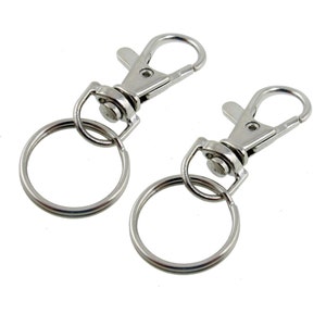 May include: Two silver keychains with a swivel clasp and a round ring.