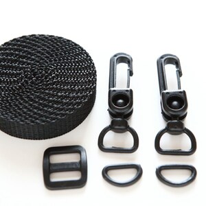 May include: Black nylon webbing, two black plastic clips, a black plastic buckle, and two black plastic D-rings.