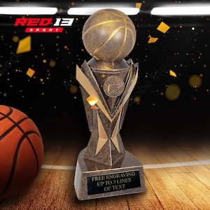 May include: A gold basketball trophy with a star on the base. The trophy has a basketball on top and a plaque that says "FREE ENGRAVING UP TO 3 LINES OF TEXT".