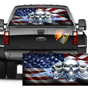 May include: A rear window truck decal featuring a waving American flag with three chrome skulls and blue lightning bolts.