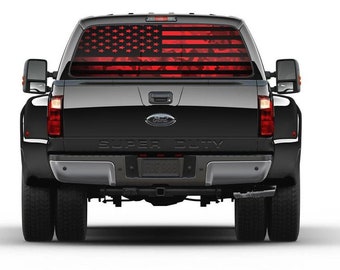 May include: Rear view of a black Ford Super Duty truck with a red and black American flag design on the rear window. The truck has dual rear wheels and a trailer hitch.
