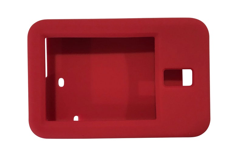 May include: Red silicone case for a tablet or e-reader. The case has cutouts for the camera, buttons, and ports.