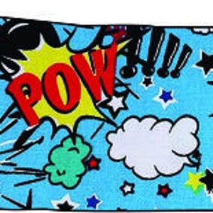 May include: A blue fabric with a colorful comic book print featuring words like "POW!" and "MOO!" with red, yellow, green, and black accents. The fabric is covered in stars and has a white cloud in the center.