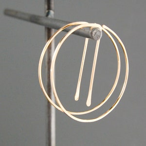 Peut inclure: Boucles d'oreilles cr&eacute;oles en or avec un design &agrave; double cr&eacute;ole. Les cr&eacute;oles sont reli&eacute;es par un fil fin.