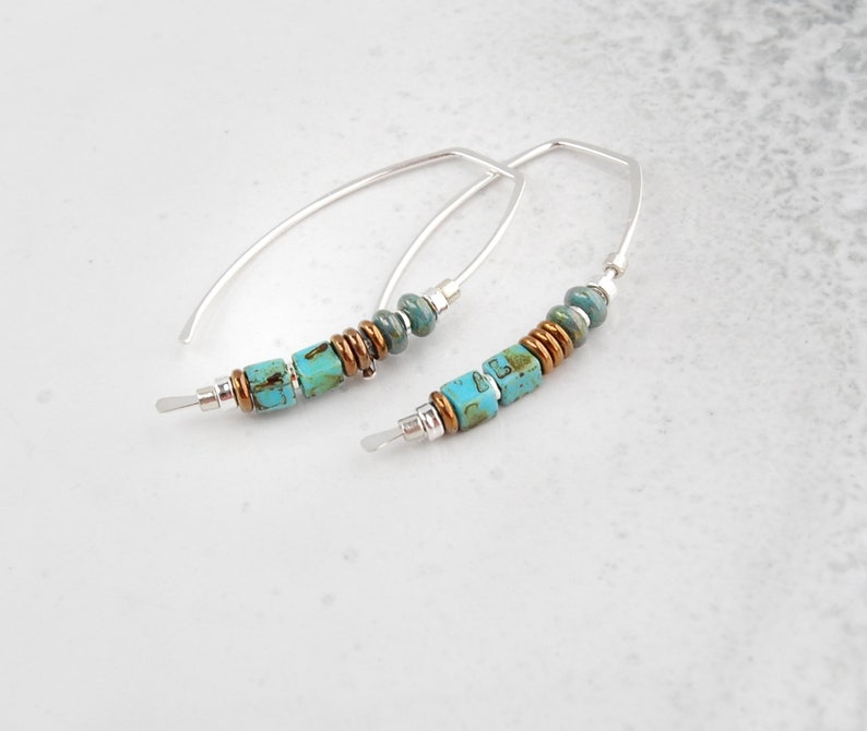 Puede incluir: Un par de pendientes de aro de plata con cuentas turquesa y cobre. Los pendientes son simples y elegantes, y ser&iacute;an un gran regalo para cualquier ocasi&oacute;n.