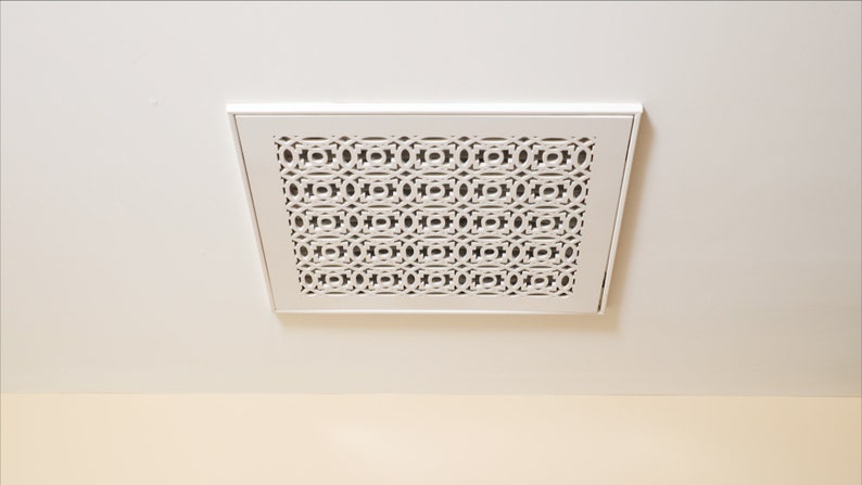 May include: White ceiling vent with a decorative, geometric pattern.