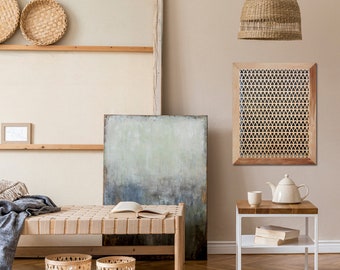 May include: A light wood bench with a woven seat cushion, a woven wall hanging, a woven lampshade, and two woven baskets. The room is decorated in a bohemian style with a light wood floor and a light beige wall.