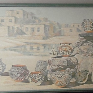 May include: A painting depicting a Southwestern pueblo village with a collection of Native American pottery in the foreground. The pottery is decorated with intricate geometric patterns in shades of brown, white, and black.