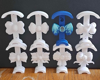 May include: White display stands with bows and a blue stand with a blue and green bow with a skull design.