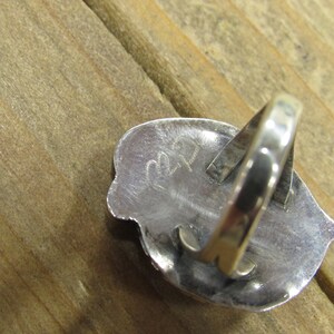May include: Silver ring with a textured design and the number "22" stamped on the back.