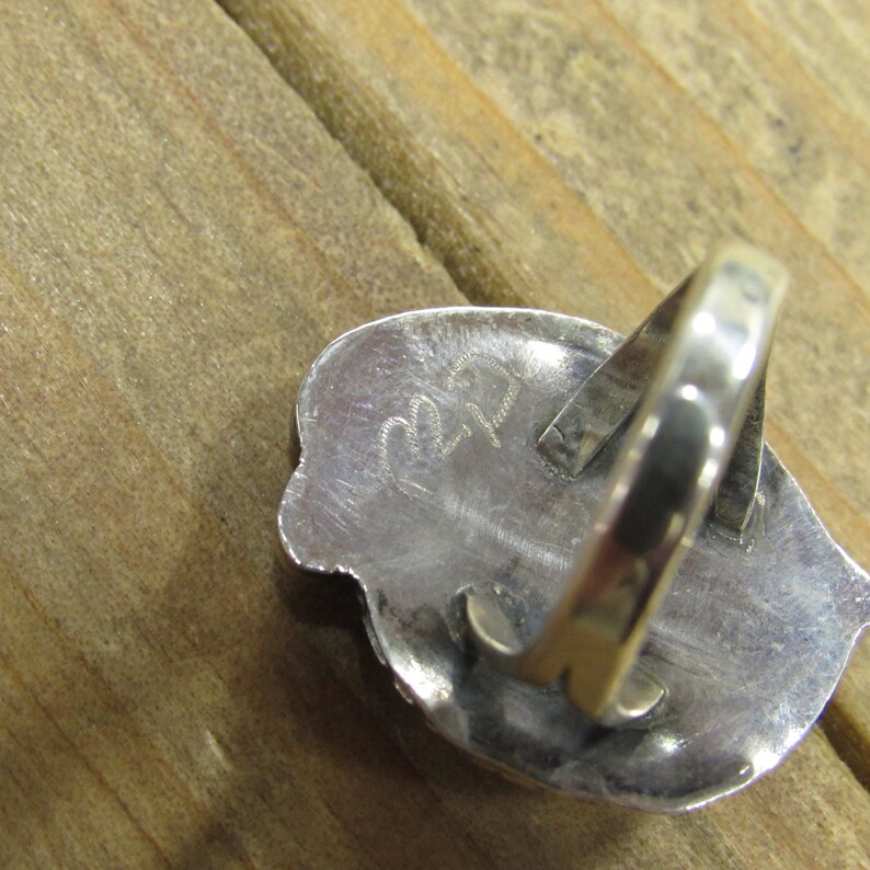 May include: Silver ring with a textured design and the number "22" stamped on the back.