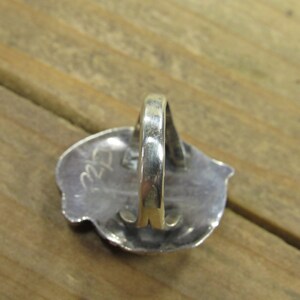 May include: Silver ring with a textured design and the number "22" stamped on the back.