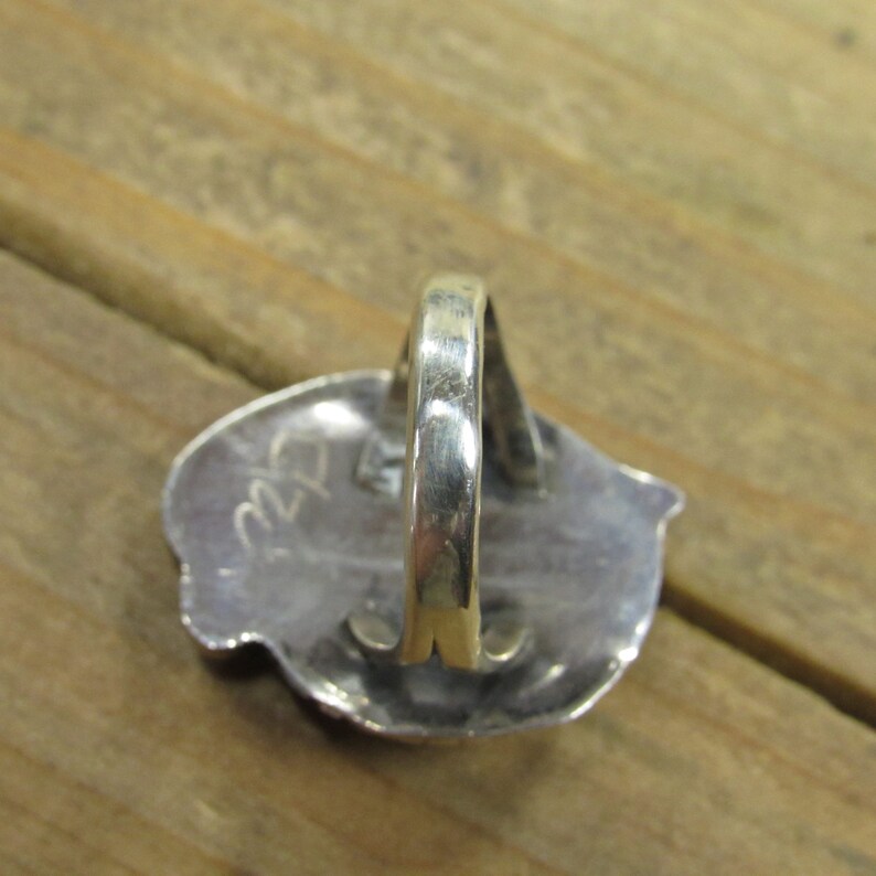 May include: Silver ring with a textured design and the number "22" stamped on the back.