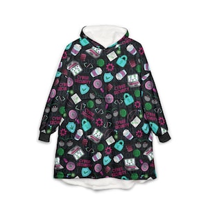 May include: Black oversized hoodie with a white fleece-lined hood and cuffs. The hoodie is patterned with teal, pink, and white cyber security-themed graphics, including laptops, padlocks, and the text "CYBER SECURITY".