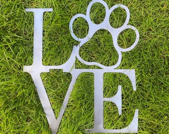 May include: Metal yard art in the shape of the word "LOVE" with a paw print in the center of the "O".