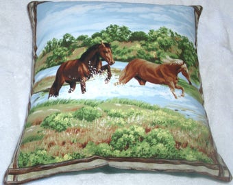 Two horses galloping through a river cushion pillow