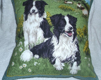 Border Collie sheepdogs in a field with sheep cushion pillow
