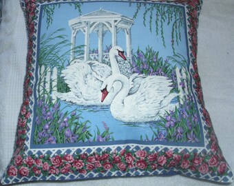 Swans on a lake with irises cushion