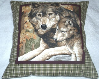 A Wolf lying with her cub in autumnal forest cushion pillow