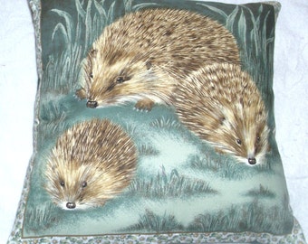A Hedgehog and her two youngsters in a moonlit garden cushioncushion