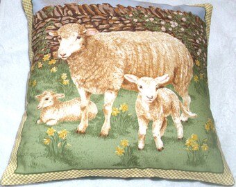 cushionOn the Farm cushion with a sheep and two lambs in Springtime pillow