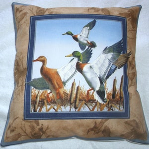 Mallards flying up out of the reeds cushion pillow