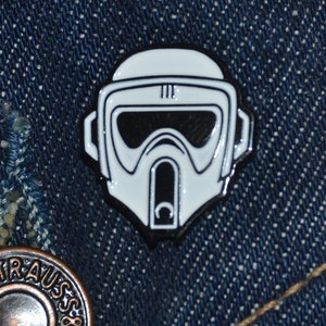May include: White enamel pin of a Star Wars Snowtrooper helmet. The helmet is black and white with a black visor.