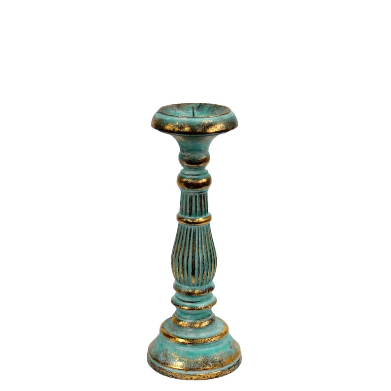 May include: A teal blue and gold candle holder with a fluted column and a round base.