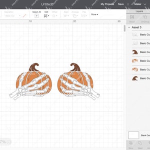May include: Two orange pumpkins with white skeletal hands holding them. The pumpkins are on a white grid background.