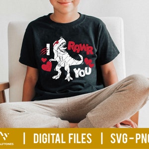 May include: A black t-shirt with a white dinosaur graphic and the text "I RAWr You" in white. There are three red hearts around the dinosaur.