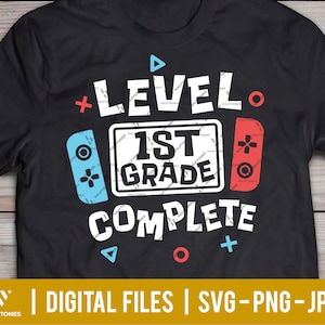 May include: Black t-shirt with a video game controller graphic and the text "Level 1st Grade Complete".